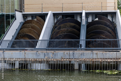 Obraz na płótnie The image shows a set of large Archimedes screws used for water management or energy generation