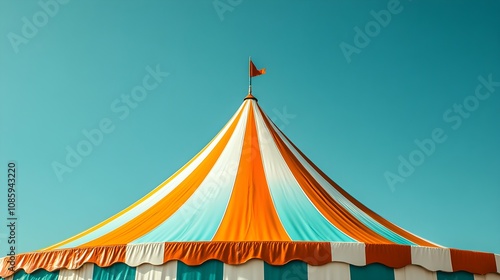 Colorful striped circus tent top against a clear blue sky, featuring orange, white, and teal vertical stripes with a central pointed top.