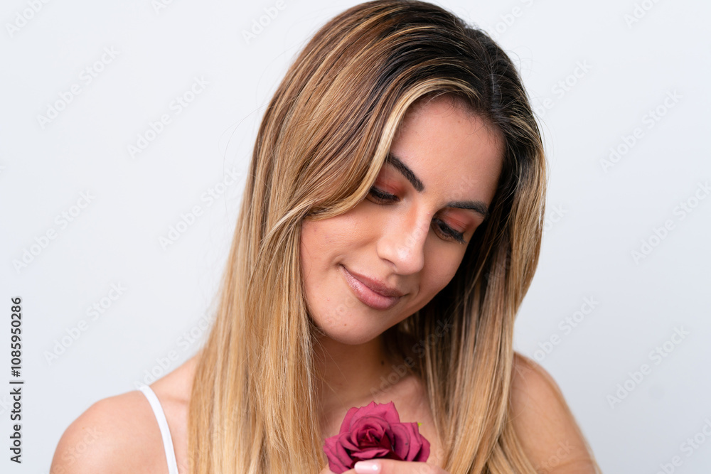 Young caucasian woman isolated on white background holding flowers with happy expression. Close up portrait Young caucasian woman isolated on white background holding flowers with happy expression. Close up portrait