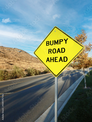 Tablou pe pânză Yellow roadside warning sign warning of bumpy road ahead
