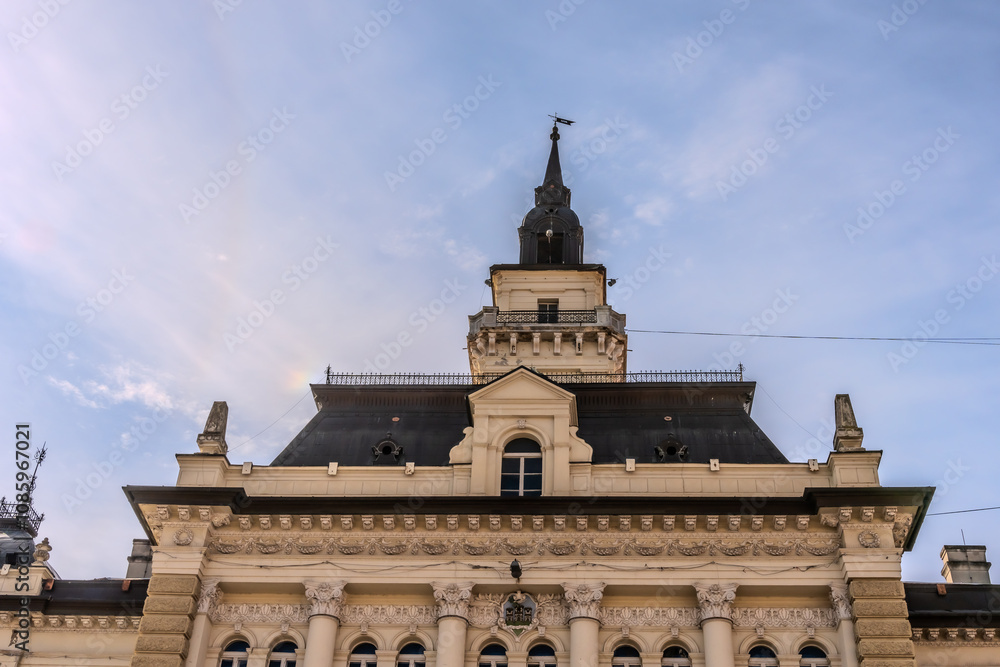 Fototapeta premium A panoramic city view of Novi Sad with its iconic bridge over the Danube River is a breathtaking sight. From this vantage point, the city sprawls beneath the sky, with the elegant Varadin Bridge