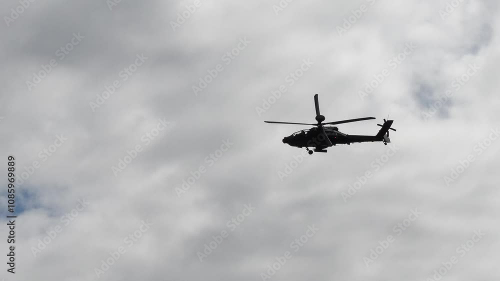 British army Boeing Apache Attack helicopter gunship AH64E AH-64E ArmyAirCorp AAC AH2 in low level flight British army Boeing Apache Attack helicopter gunship AH64E AH-64E ArmyAirCorp AAC AH2 in low level flight
