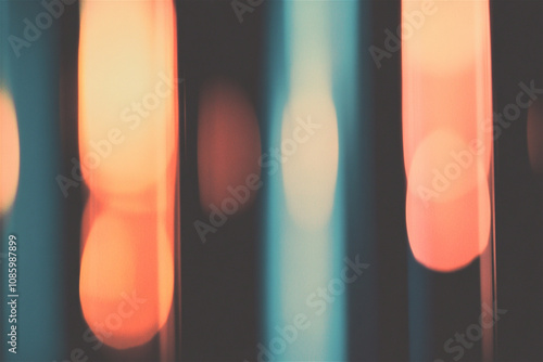 Blurred orange and turquoise lights creating a beautiful bokeh effect against a dark background, perfect for backgrounds and design projects