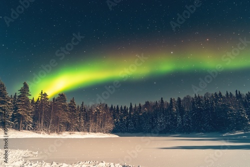 Auroral display lights up the night sky above a frozen lake, with icy landscape and starry background photo