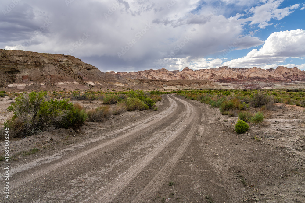 Scenic Desert Landscape with Dirt Road and Dramatic Sky in Utah Scenic Desert Landscape with Dirt Road and Dramatic Sky in Utah