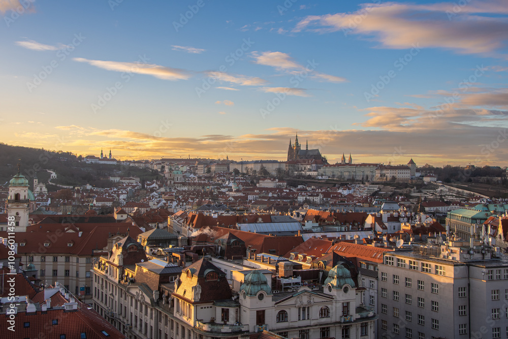 Obraz premium The view from the Old Town Hall over the roofs to Prague Castle in the evening sun