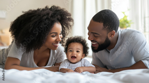 Loving Family Moments: Parents Smiling at Their Adorable Infant Lying on Bed, Creating Cherished Memories Together in a Bright Indoor Space