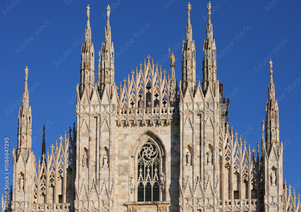 Detail of Facade of Cathedral of Milan also called DUOMO DI MILANO in italian language and golden statue of Virgin Mary Detail of Facade of Cathedral of Milan also called DUOMO DI MILANO in italian language and golden statue of Virgin Mary
