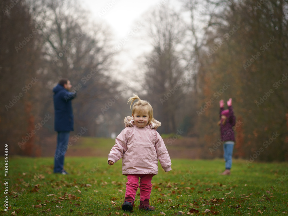 A touching moment of father and daughters sharing a playful day in the park, perfect for content about family relationships, childhood memories, or promoting family-friendly products and services. A touching moment of father and daughters sharing a playful day in the park, perfect for content about family relationships, childhood memories, or promoting family-friendly products and services.