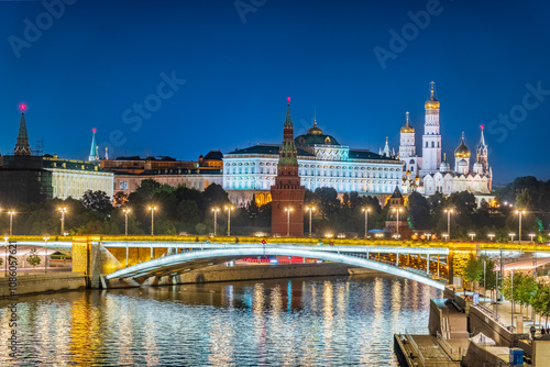 Illuminated Moscow Kremlin and Bolshoy Kamenny Bridge at summer night. View from the Patriarshy pedestrian Bridge photo