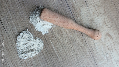 Zeolite mesolite raw powder on wooden background. Zeolite in a wooden mortar with a pestle. photo