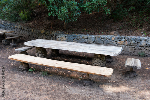 wooden table and bench in forest. Picnic spot on hiking trail