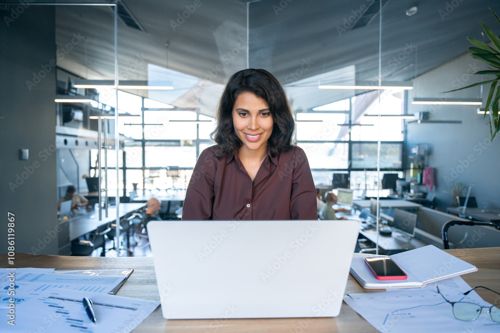 Young businesswoman professional employee using pc doing online banking analysing at workplace. Latin hispanic middle age business woman working on laptop computer in modern office. Banner, copy space Young businesswoman professional employee using pc doing online banking analysing at workplace. Latin hispanic middle age business woman working on laptop computer in modern office. Banner, copy space