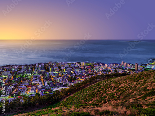 Early evening view of Sea Point buildings and streets lit up after sunset, Cape Town, South Africa