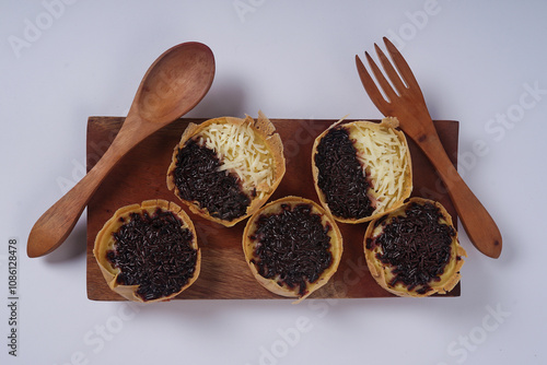 Martabak mini or terang bulan mini is Indonesian popular street food, made from flour, egg, yeast, topped with cheese or chocolate. Mini sweet martabak isolated on white background. photo