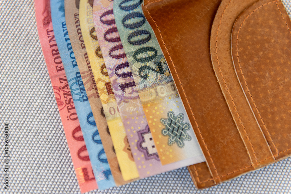 Obraz premium Hungarian forint banknotes in a brown leather wallet.