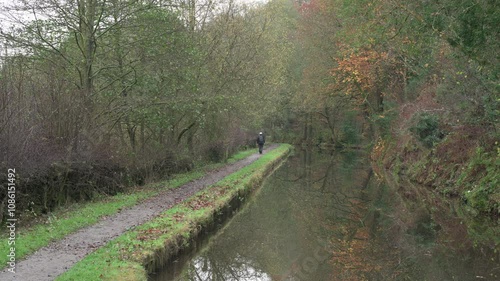 DENFORD, STAFFORDSHIRE, ENGLAND - NOVEMBER 12 2024: Elderly man walking along the Caldon canal. photo