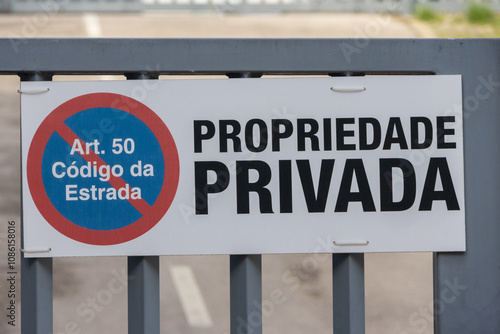 Private property sign on metal gate in portuguese language