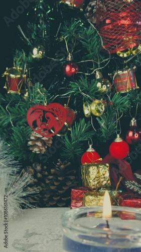 Close up of decorated Christmas tree with twinkling lights, vertical video, details. Scene background.
