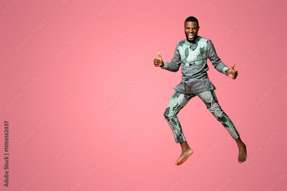 Joyful black guy showing thumbs up and jumping up on pink, studio shot, full length photo. Happy african american man feeling good, celebrating success over pink background, copy space Joyful black guy showing thumbs up and jumping up on pink, studio shot, full length photo. Happy african american man feeling good, celebrating success over pink background, copy space
