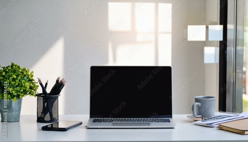 laptop with blank screen and office supplies on white table in office laptop with blank screen and office supplies on white table in office