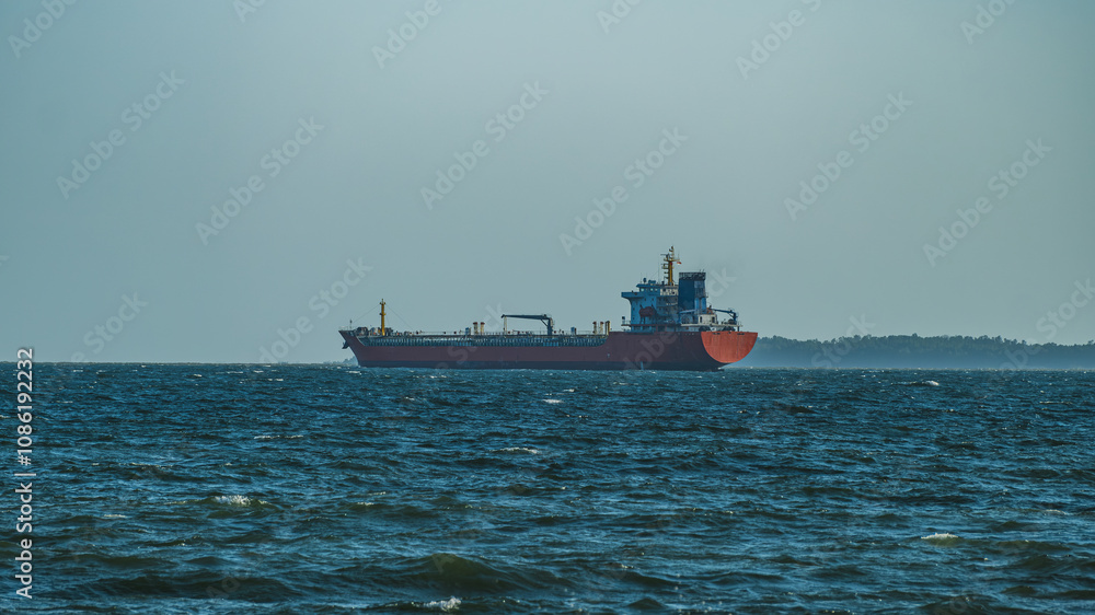Fototapeta premium Cargo Ship on the Horizon, Balikpapan Bay.