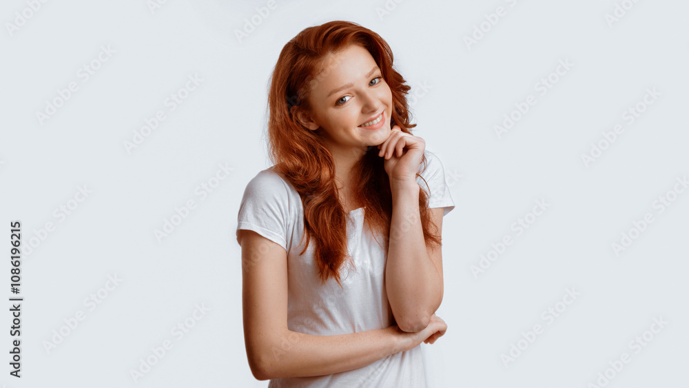 Cute Red-Haired Teen Girl Posing Smiling To Camera Standing Over White Studio Background. Panorama Cute Red-Haired Teen Girl Posing Smiling To Camera Standing Over White Studio Background. Panorama