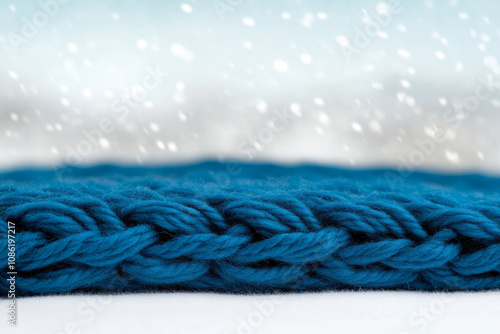 A blue knit scarf with snowflakes on it