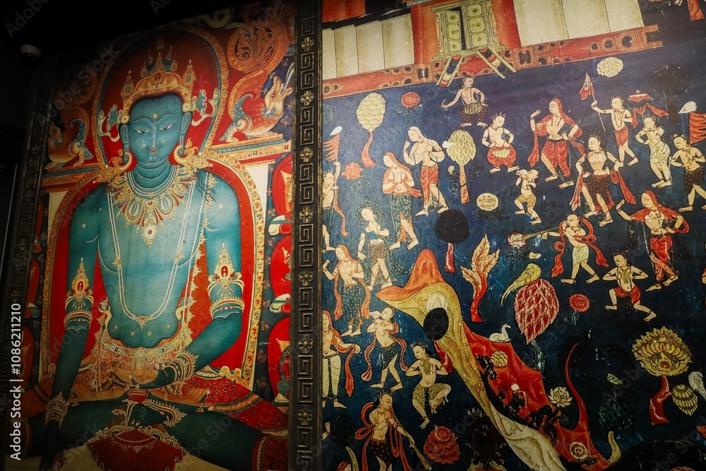 Obraz premium Colorful Thangka painting depicting a serene deity and intricate scenes, showcased at the Tibet Museum in Lhasa, Tibet, during a 2024 exhibition.
