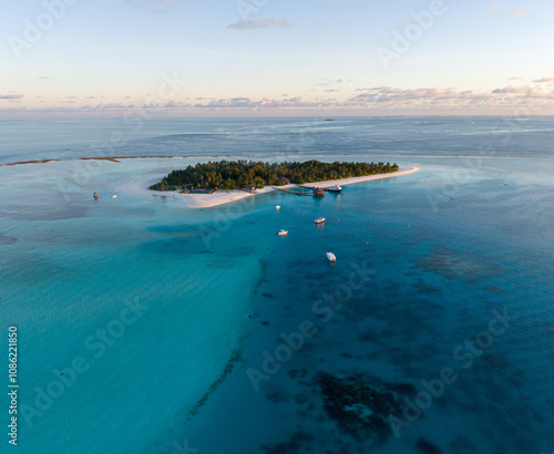 Aerial views of Velavaru Island at sunset in Maldives photo