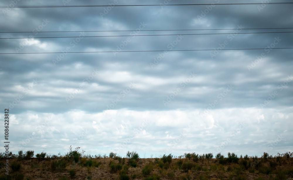 Overcast sky with dark clouds. Dark sky before a thunder-storm. The gray cloud background before rain. Overcast sky with dark clouds. Dark sky before a thunder-storm. The gray cloud background before rain.