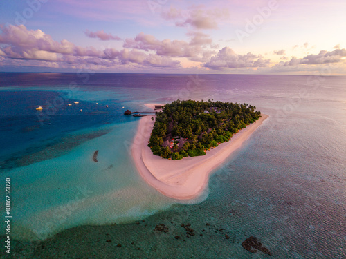 Aerial views of Velavaru Island at sunset in Maldives photo