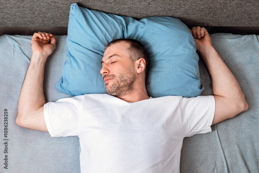 Fototapeta premium Mature Man Sleeping Lying In Bed In Bedroom Staying At Home During Self-Quarantine. Top View