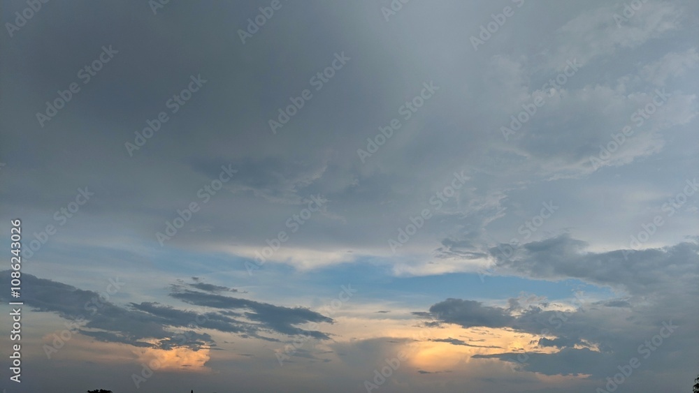 A dramatic sky with a mix of dark, stormy clouds and a vibrant sunset. The clouds create a sense of depth and movement, while the warm hues of the sunset provide a striking contrast. A dramatic sky with a mix of dark, stormy clouds and a vibrant sunset. The clouds create a sense of depth and movement, while the warm hues of the sunset provide a striking contrast.