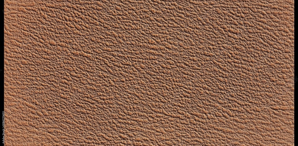 Close-up of a textured brown surface with a rough, uneven pattern. Close-up of a textured brown surface with a rough, uneven pattern.