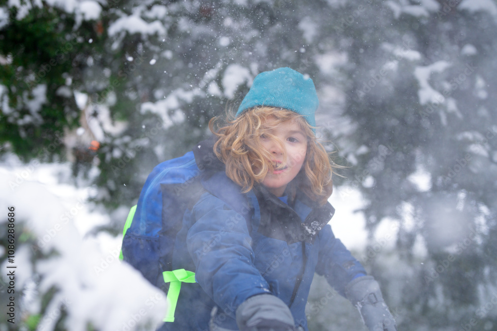 Child play with snow in winter park. Kids with first snow. Child winter holiday. Smiling boy playing with snow in winter park. Portrait of a little kid in knit hat throw snowballs. Funny kids in snow. Child play with snow in winter park. Kids with first snow. Child winter holiday. Smiling boy playing with snow in winter park. Portrait of a little kid in knit hat throw snowballs. Funny kids in snow.