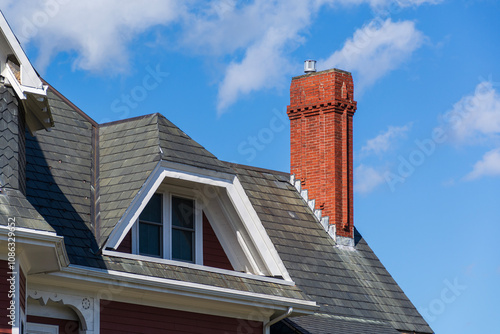 Canvas Print Red brick chimney and gable dormer on a historic house roof in Brighton, Massach