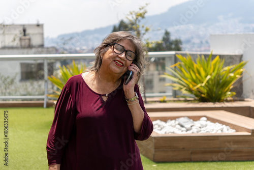 Senior woman talking on cell phone on terrace