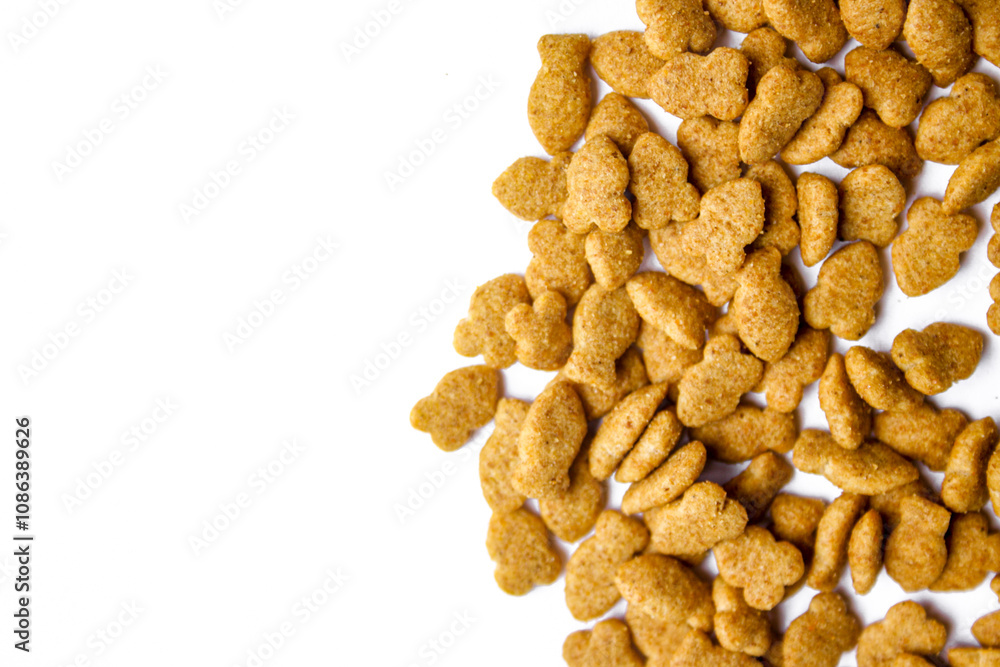 Fototapeta premium Scattered dry cat food isolated on white background
