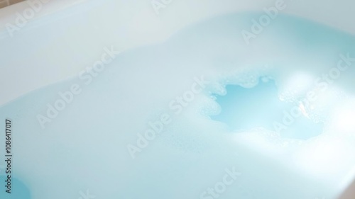 Soft blue foam soap suds float on a bathtub, bubble bath, spa, calming atmosphere