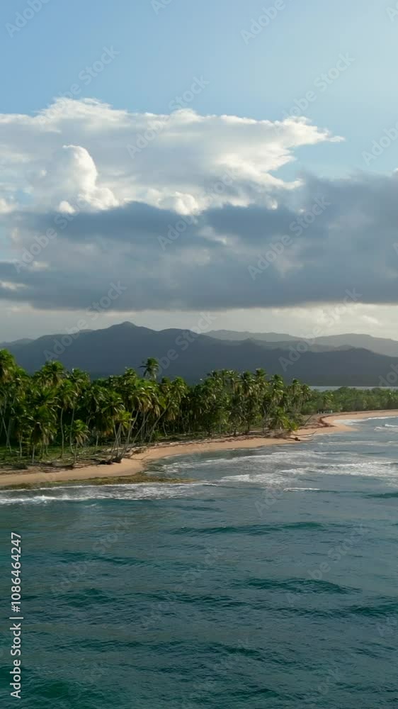 Vertical aerial view of large caribbean beach at sunset. Cordillera Central mountain range in the background. Miches, Dominican Republic Vertical aerial view of large caribbean beach at sunset. Cordillera Central mountain range in the background. Miches, Dominican Republic
