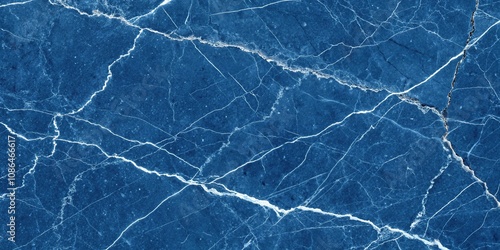 A close-up of a deep blue marble surface featuring a network of cracks and fissures, rock, pattern, organic, geological formation, earth sciences