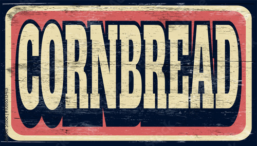 Aged and worn cornbread sign on wood
