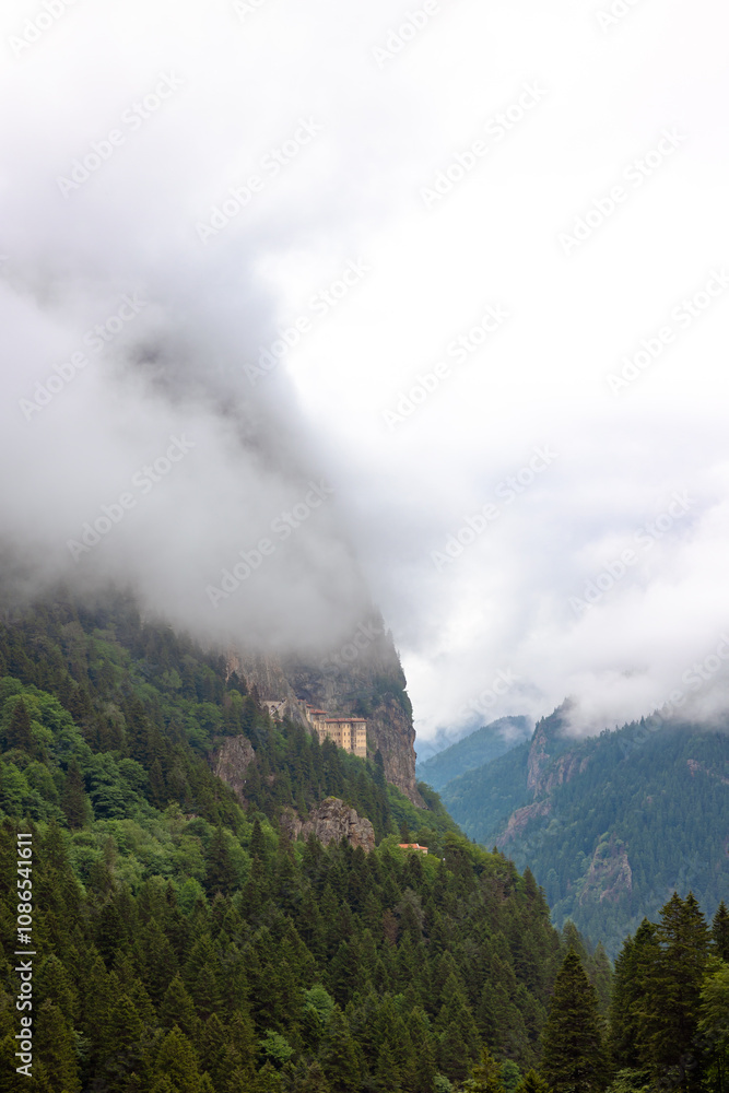 Fototapeta premium Sumela Monastery and misty mountains and forest covered hills