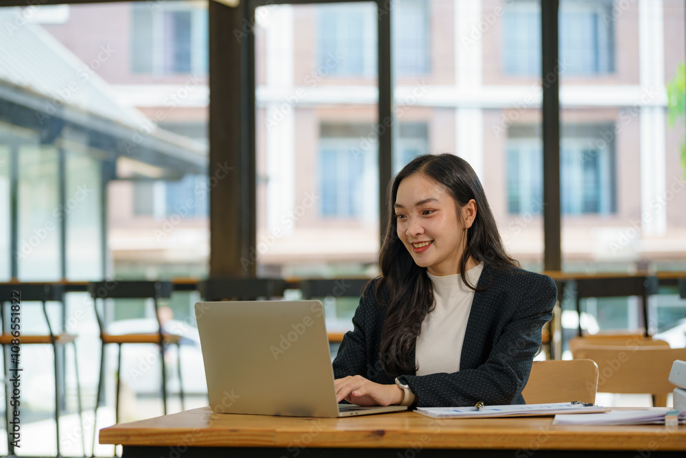 Asian businesswoman working with a laptop at the office. Asian businesswoman working with a laptop at the office.