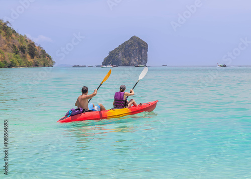 Tourists couple kayaking tour explore in turquoise sea,Krabi, Thaiand,summer holidays concept  photo