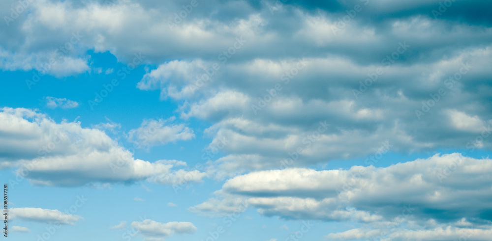Photo of fluffy white clouds and bright blue sky. Photo of fluffy white clouds and bright blue sky.