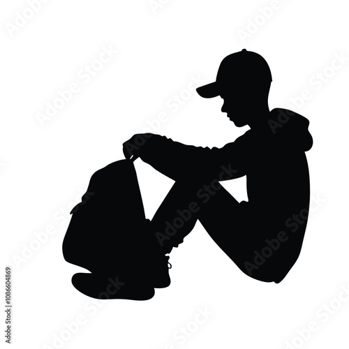 A man is sitting on the ground with a backpack on his lap. He is wearing a hat