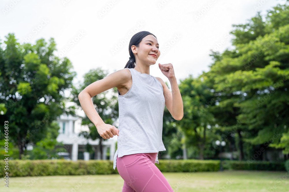 Asian beautiful sportswoman doing running exercise alone in the garden. Asian beautiful sportswoman doing running exercise alone in the garden.