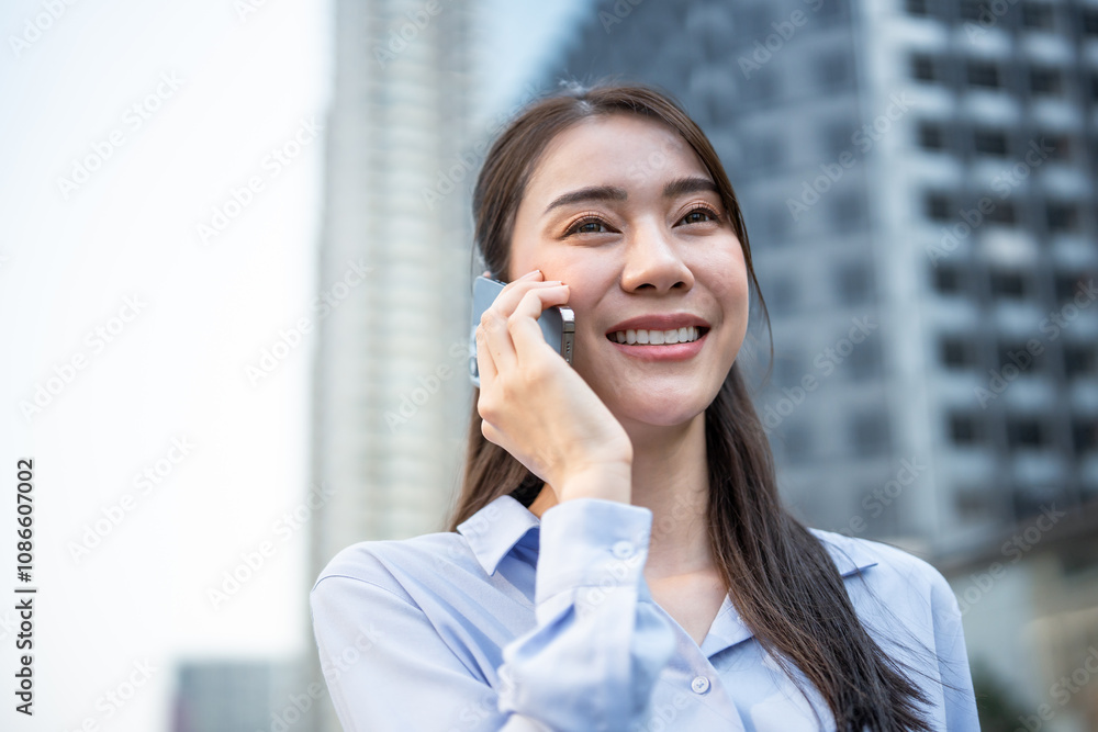 Asian young businesswoman talking on smartphone while walk in the city. Asian young businesswoman talking on smartphone while walk in the city.
